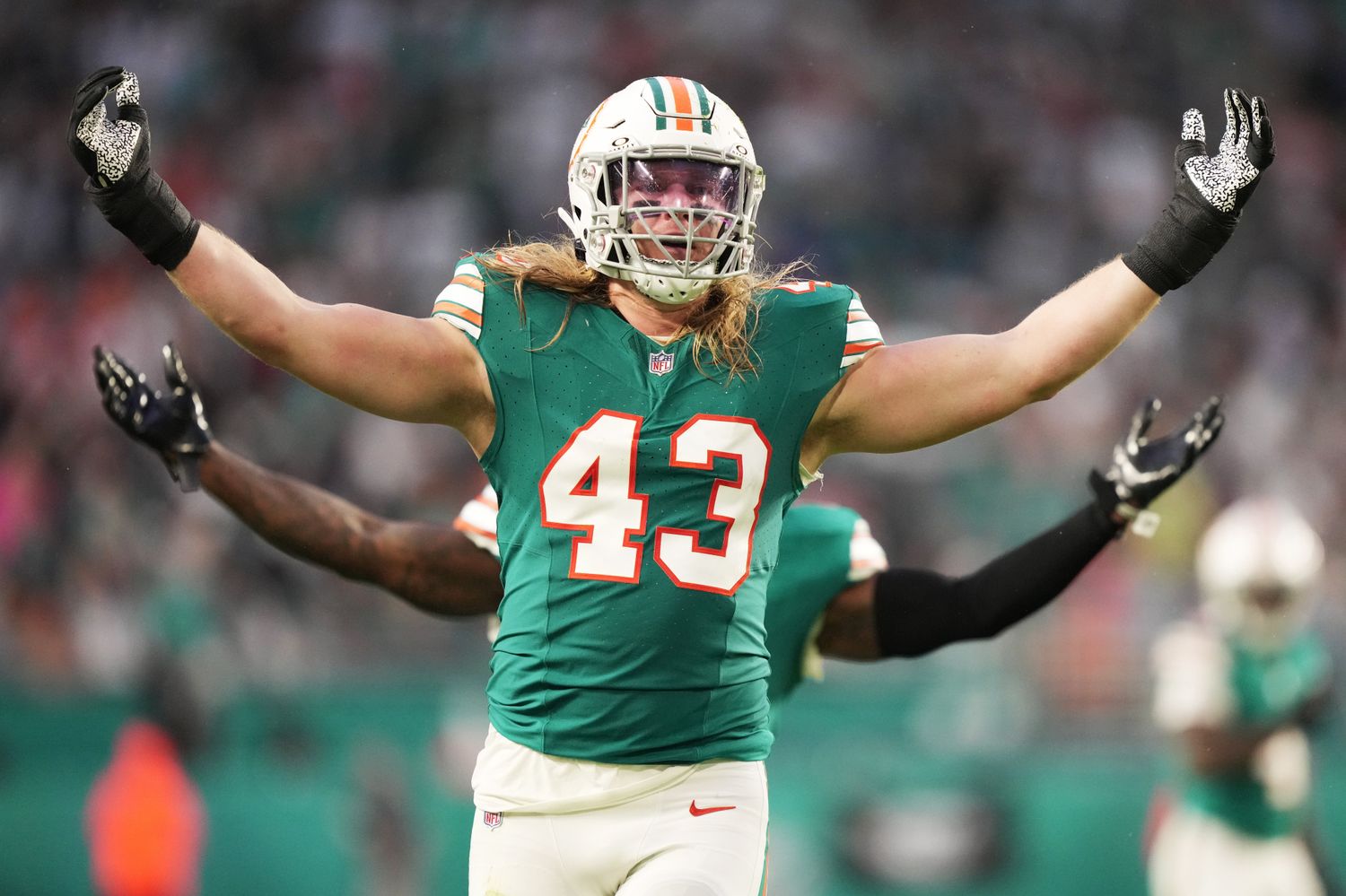 Miami Dolphins linebacker Andrew Van Ginkel (43) and linebacker David Long Jr., rear, celebrate a sack against the Dallas Cowboys during the first half of an NFL game at Hard Rock Stadium in Miami Gardens, Dec. 24, 2023.  